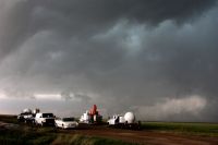 Weather conditions A fleet of VORTEX2 vehicles tracks a supercell thunderstorm near Dumas. The blue-green color in the cloud is associated with large hail. climate,meteorology,lightning