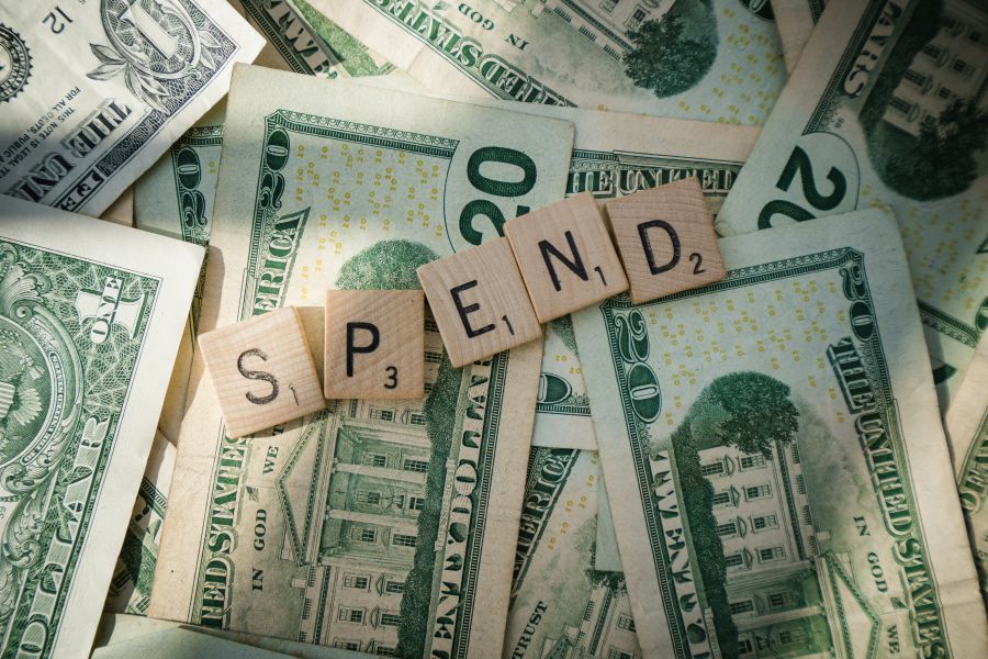 Finance Deficit Scrabble letters spelling 'spend' on American bills 