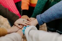 community support girl friends hands piled togethger 