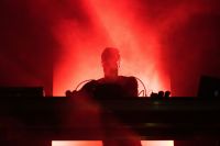 DJ fire DJ playing music in red lights 