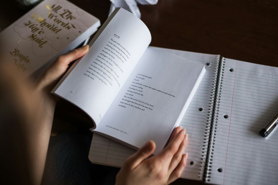 Poet Young person reads poetry book 