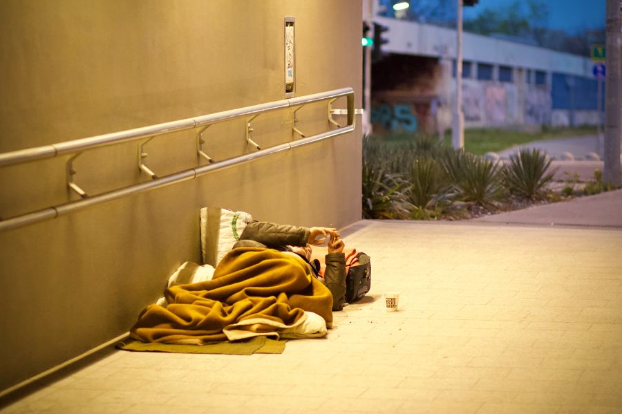 Homeless Street During my regular walk back home I went by this poor guy lying on the street smoking a cigarette. He had this “cozy” living room, an underground tunnel with a nice view to the other side of the street. He might have his own joke to the world, look at his cup, it says: “Who are you?”. homeless,street,living on the street
