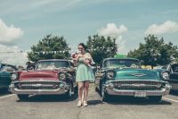 Vintage festival Woman between vintage cars 