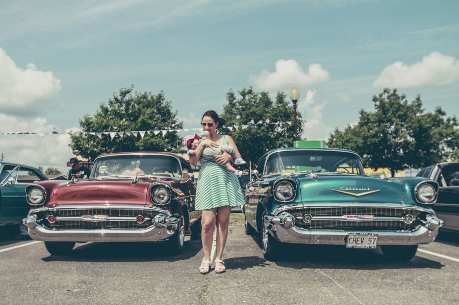 Vintage festival Woman between vintage cars 