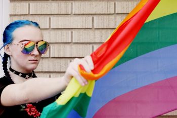 Transgender activism Portrait of a person holding a rainbow flag. advocacy,questioning,gender fluid