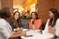 Women Four women working in a business meeting in a cafe coffee shop 