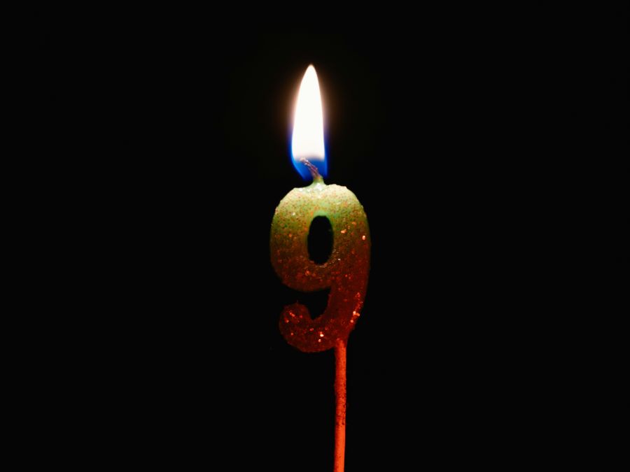 DDay anniversary Burning birthday candle isolated on black background, number 9 candle,fire,close up