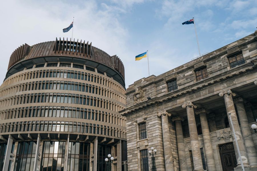 City council New Zealand Parliament Buildings in Wellington, New Zealand with the Beehive, Parliament House and the Parliamentary Library. The Ukraine flag can be seen raised. 