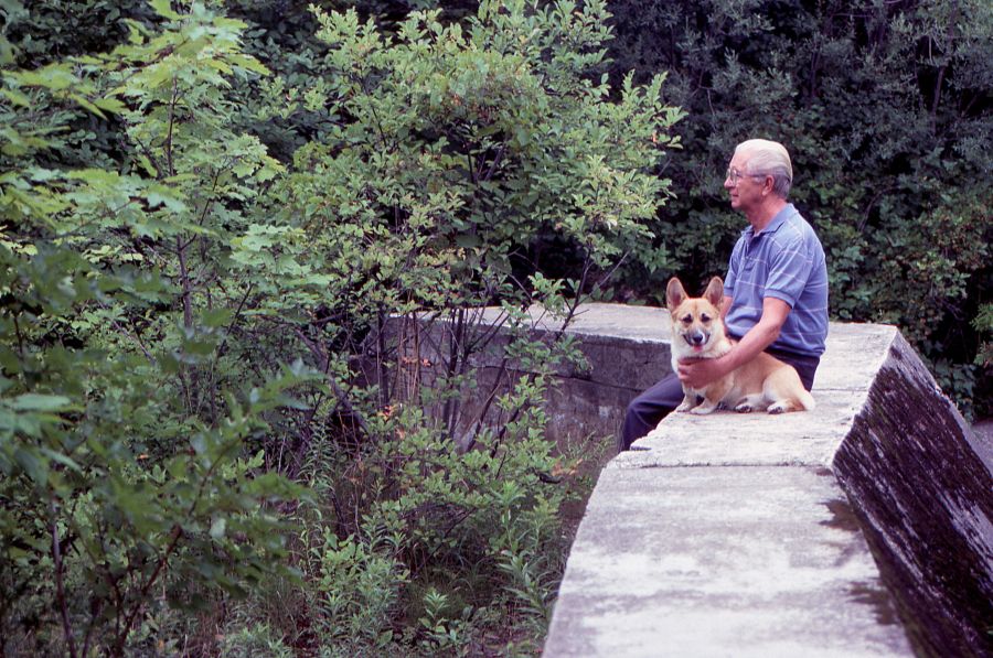 Companions Brotherhood A senior man enjoys a relaxing moment in nature with his trusty best friend a Pembrokeshire Welsh Corgi. man and dog,best friends,peaceful moment