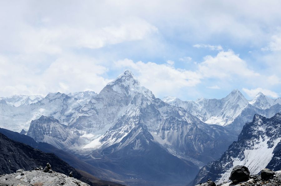 mountains A snow covered Ama Dablam with blue skies and clouds in Sagarmatha national park in Nepal, on the way to Everest Base Camp. 