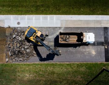 roadwork construction This drone shot came from the progress on the high school track in town. The old track needed to be tore completely out, the base dried out, and a new base laid. Truck after trucked hauled the old asphalt out. It was amazing to watch them work.