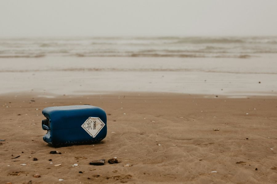 environmental issues Washed up toxic litter on a beautiful beach. beach litter,environmental issues,pollution