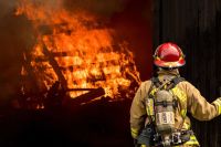 Firefighters Lieutenant observing the practice fire fire,helmet,turnout gear