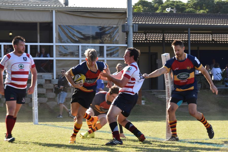 Rugby match Group of young men playing rugby in South Africa, holding a rugby ball, sunny afternoon, in club colours. rugby pitch,drag,pull