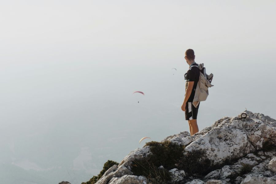 Randonnée Hiking A man at the top of mountain watching three paragliders aix-en-provence,france,hiking