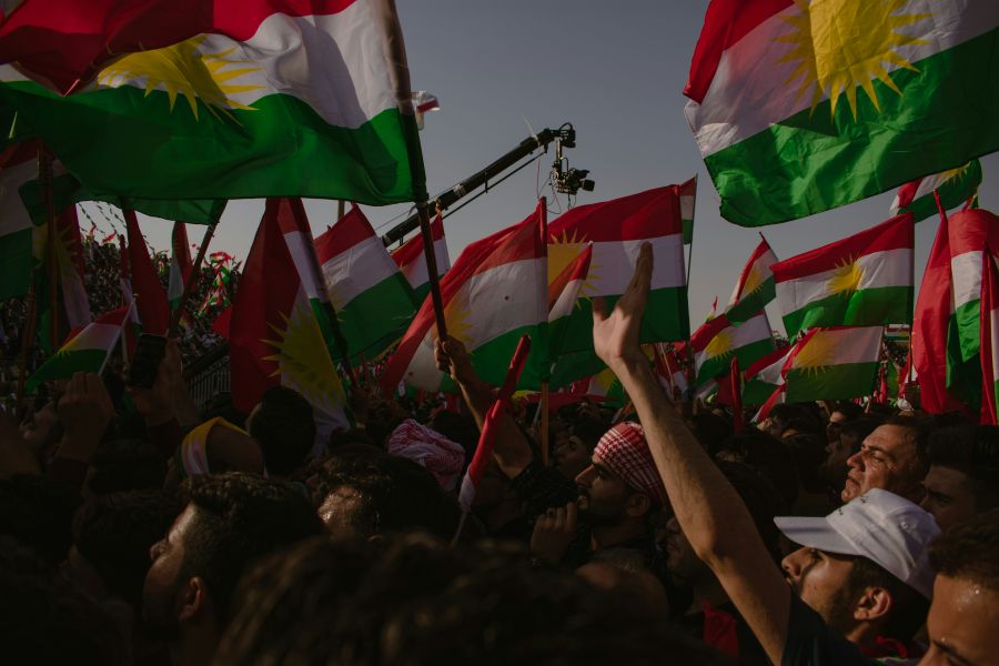 Kurdish Kurds waving the flag of the Kurdistan Region in Erbil. 