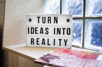 Startups Turn Ideas into Reality! A motivational sign in a Co-Working Space.  current events,deutschland,co-working