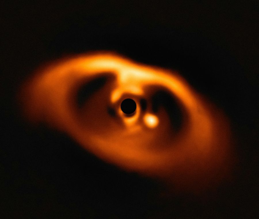 protoplanetary disk Protoplanetary Disk Around PDS 70 Caption: The European Southern Observatory’s Very Large Telescope caught the first clear image of a forming planet, PDS 70b, around a dwarf star in 2018. The planet stands out as a bright point to the right of the center of the image, which is blacked out by the coronagraph mask used to block the light of the central star. Credits: Image - ESO, VLT, André B. Müller (ESO) 