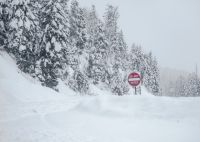 Winter tourism Do Not Enter sign along a very snowy mountain road. united states,colorado,road sign