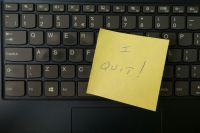 Resignation I quit written on a post it note, stuck to a keyboard. keyboard,computer,yellow