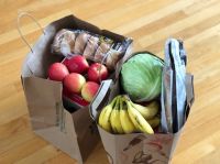 food donation Paper bags with groceries including fruits and vegetables and bread 
