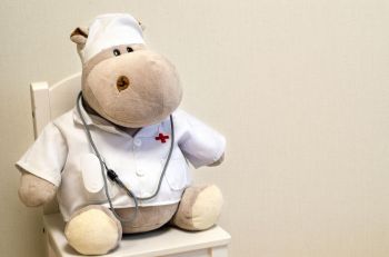 pediatrics humor A toy hippo doctor with oximeter