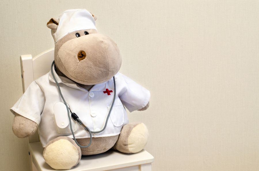 pediatrics humor A toy hippo doctor with oximeter 