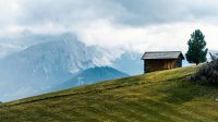 mountain cabin Cabin on a mountain slope overlooking the Dolomites Mountains, Italy 