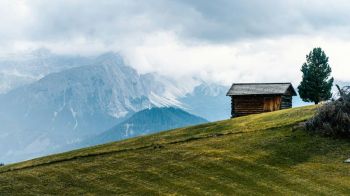mountain cabin Cabin on a mountain slope overlooking the Dolomites Mountains, Italy 