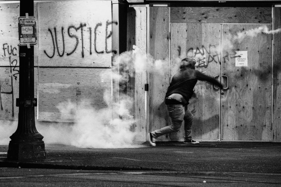 protests vandalism Protester throws tear gas canister back at police during a Black Lives Matter protest in Portland, Oregon. People have been protesting police brutality and the deaths of several members of the Black community - sparked by the recent death of George Floyd. 