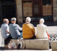 elderly council Four elderly Spanish people sitting on a bench 