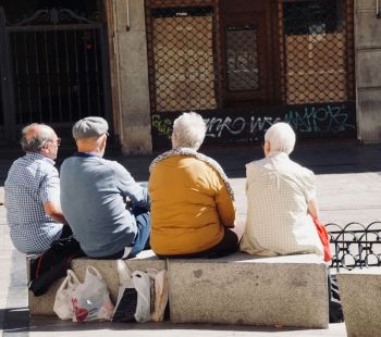 elderly council Four elderly Spanish people sitting on a bench