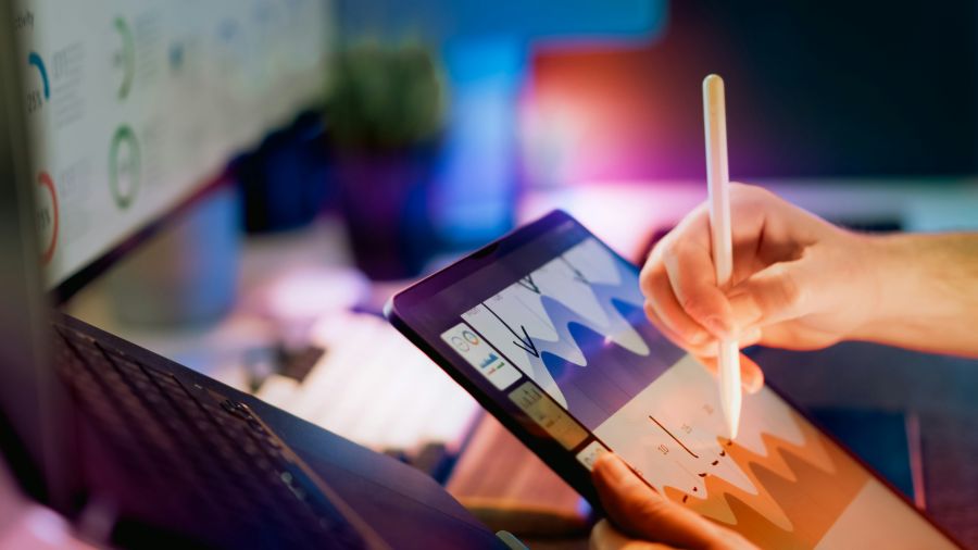 Technology trends Tablet analytics chart touchscreen data visualization concept showing hand using stylus to edit colorful graph in digital workspace environment 