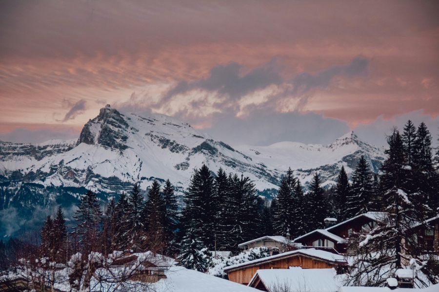 chalet mountain Beautiful view of mountains, houses and pine trees covered with snow. 