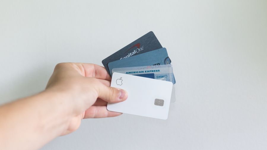 Debt A person holding credit cards against a white background wall. usa,louisville,ky