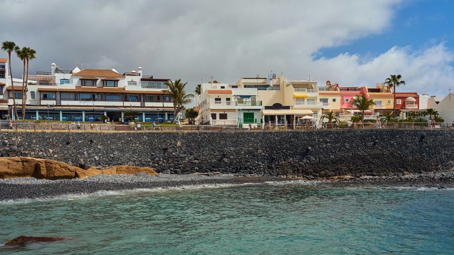 Shopping destination The promenade of the Canarian city La Caleta is characterized by colorful houses and palm trees.  architecture,sea,vacation