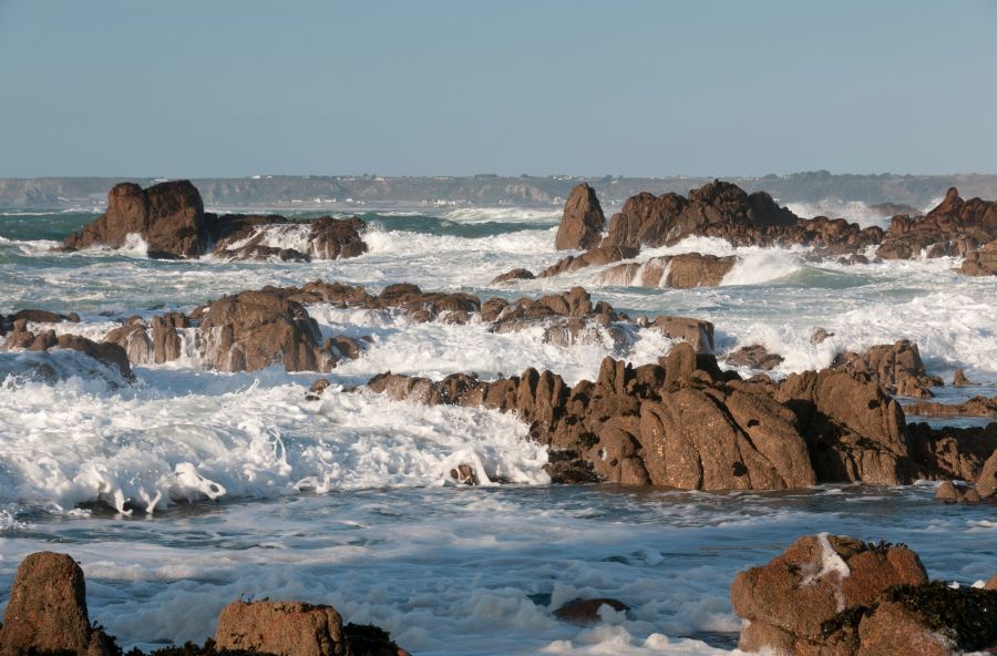 Strong winds Surf and rocks looking across St. Ouen’s Bay from Corbière Lighthouse Causeway, St. Brelade, Jersey, Channel Islands sea,landscape,rock