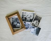 Memory family Overhead view of old black and white family photos with overlapping wood frame. 