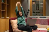 work rest Young woman stretching while doing remote work in relaxing office environment 