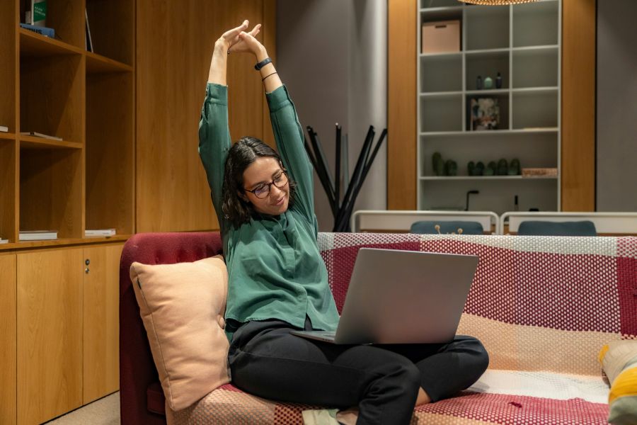 work rest Young woman stretching while doing remote work in relaxing office environment 