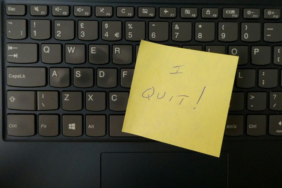 resignation I quit written on a post it note, stuck to a keyboard. 