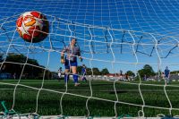 Soccer Football Soccer ball hitting the back of the net while the goalkeeper looks back in disgust during a women's football game. canada,soccer,soccer ball