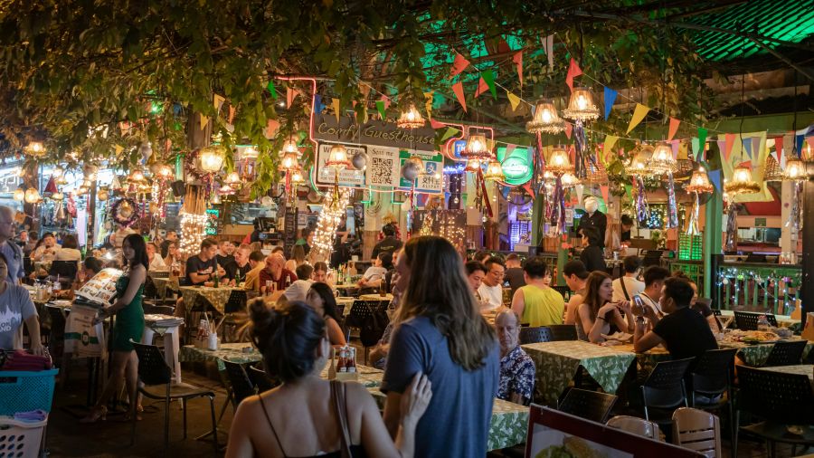 Street food People in an open air restaurant at night time 