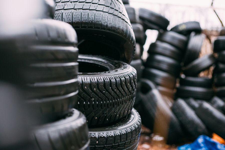 Recycled tires Pile of used tires. Daylight photo with minimum editing. Good for illustration in different kinds of automotive editorials. Model in the center is Goodyear Ultra Grip studded winter tire. 