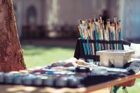 Art event paintbrushes on outdoor table 
