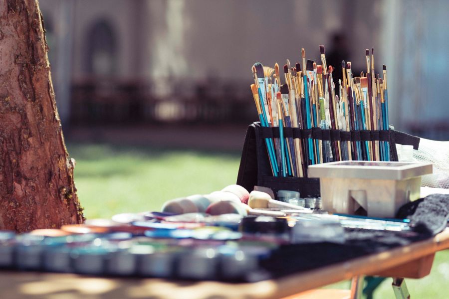 Art event paintbrushes on outdoor table 