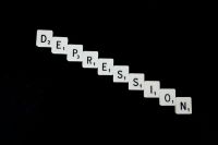 Depression Philosophy Depression, spelled out in white scrabble tiles. 