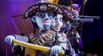 puppets theater Traditional Brazilian mamulengos (string puppets) dressed as cangaceiros, the legendary bandits of northeastern Brazil. These articulated folk art puppets wear decorated leather hats with stars and gems, bandoliers, and carry wooden rifles, representing the iconic outlaw culture of the Brazilian sertão. The handcrafted dolls showcase the rich puppetry traditions of Northeast Brazil's popular culture.