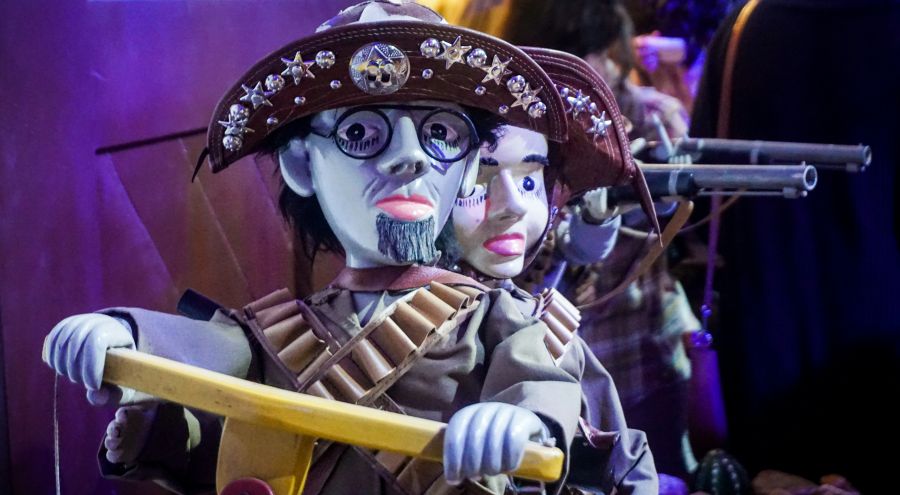 puppets theater Traditional Brazilian mamulengos (string puppets) dressed as cangaceiros, the legendary bandits of northeastern Brazil. These articulated folk art puppets wear decorated leather hats with stars and gems, bandoliers, and carry wooden rifles, representing the iconic outlaw culture of the Brazilian sertão. The handcrafted dolls showcase the rich puppetry traditions of Northeast Brazil's popular culture. 