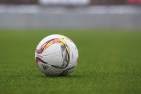 Football Adidas soccer ball on a grass pitch 